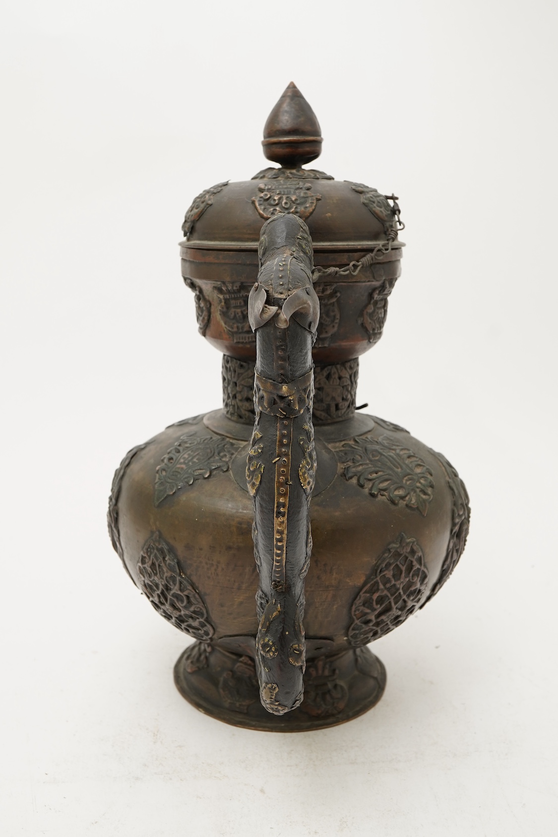 A large Tibetan repoussé brass and copper ewer, 19th century